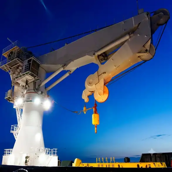 Offshore crane lifting heavy cargo at sea – durable marine deck crane for ships